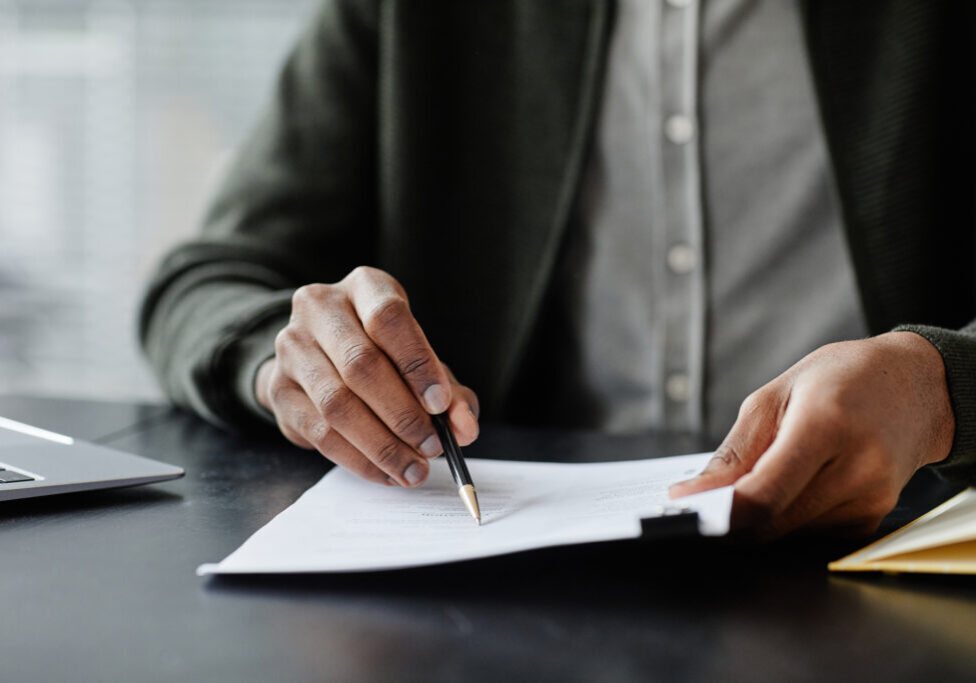 person holding estate planning document and changing it. Making changes to trust and will documents. Revocable living trust changes