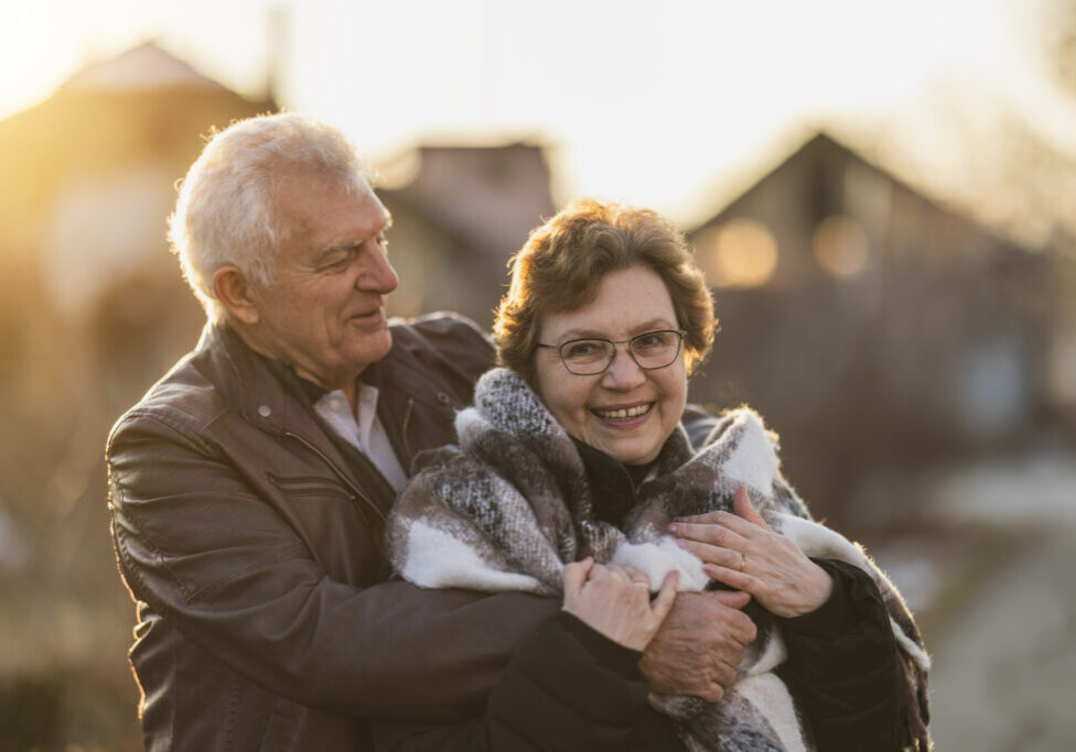 Portrait of a happy senior couple are hugging each other in a close embrace, sharing a moment of connection and love.